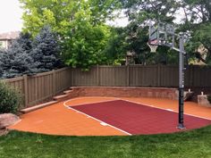 an outdoor basketball court in the backyard