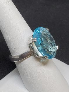 Blue topaz is very attractive, inexpensive, and a favorite color of the jewelry customer. These characteristics drive the popularity of blue topaz. Before 1970 most of the topaz in low to moderate price jewelry was yellow to brown in color. Natural topaz with an attractive blue color was rare.  18 x 16 mm Stone, in Oval shape. Oval Light Blue Topaz Ring, Light Blue Oval Topaz Ring, Turquoise Topaz Ring In Fine Jewelry Style, Formal Blue Topaz Filigree Ring, Formal Round Topaz Ring, Turquoise Topaz Anniversary Ring, Turquoise Topaz Ring, Anniversary Fine Jewelry Topaz Ring With Large Stone, Classic Blue Topaz Ring With Vs Clarity