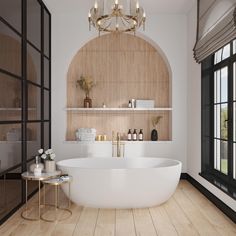 a large white bath tub sitting in a bathroom next to a wooden shelf with candles on it