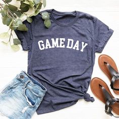 Game Day Shirt, Baseball Game Day Shirt, Sports Game Fan Shirt, Sports Shirt For Women, Sporty Mom Shirt, Play Ball Shirt Thank you so much for choosing us! How To Order 1️⃣ Please review all the information provided before placing an order. 2️⃣ Select the shirt type and size using the drop down menu. 3️⃣ Select the color of the shirt using the following drop down menu. 4️⃣ Once all your desired items are in your cart you may complete your order by entering your payment method, desired shipping Sporty Letter Print Shirt For Workout, Casual Moisture-wicking Tops For Game Day, Sports Fan Apparel Tops With Slogan, Team Spirit Shirt With Letter Print For Sports Season, Sports Season Team Spirit Shirt With Letter Print, Sporty Team-colored Shirt For Game Day, Sporty Shirt With Letter Print For Sports Season, Sporty Shirt With Letter Print For Sports Events, Sporty Shirt For Football Season