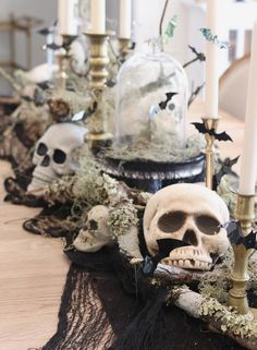 a table topped with skulls and candles