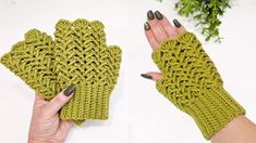 a pair of green crocheted mittens sitting on top of a table next to a woman's hand