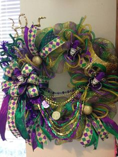 a wreath with purple and green decorations on it