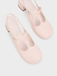 Add a girlish charm to your look with these T-bar Mary Jane pumps. Soft, rounded contours complement the delicate straps while the glossy light pink finish will instantly captivate those with a love for the colour. The simple and minimalist design also allows the sweet, pastel hue to shine. Fitted with elasticised slingback straps and set on sturdy 4.5cm block heels, these are shoes you can wear and walk in for hours. Yellow Checkered, Brand Collaboration, Faux Leather Heels, Size Chart For Kids, Mary Jane Pumps, Charles Keith, Pink Shoes, Cut Out Design, Powder Pink