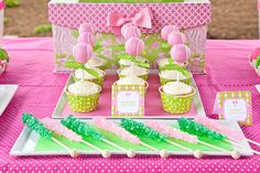 pink and green dessert table with cupcakes