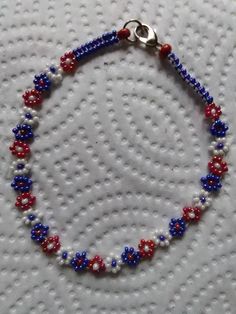 This Bracelet was Handmade by me. It is 8 1/2 inches long and 1/3 inch wide. It is in Patriotic Red, White, and Blue. It is a Double Woven Daisy Chain. It has a Lobster Claw Clasp. The beads are size 11 Czech Seed Beads in Iris and Luster beads. This would be a great bracelet to go with your 4th of July Outfit. Please take a close look at my work. Thank You So Very Much for your Interest Patriotic Red Beaded Bracelets As Gift, Handmade Patriotic Bracelets For Gift, Handmade Patriotic Beaded Bracelets For 4th Of July, Patriotic Red Beaded Bracelets For Independence Day, Patriotic Handmade Bracelet Jewelry, Handmade Patriotic Bracelet Jewelry, Patriotic Red Beaded Bracelet With Round Beads, Handmade Patriotic Blue Beaded Bracelets, Handmade Blue Patriotic Jewelry