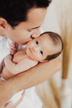 a man holding a baby in his arms