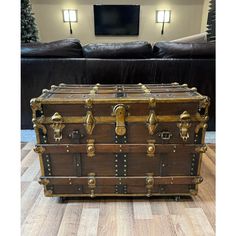 an old trunk sitting on top of a hard wood floor