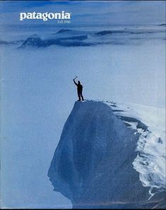 a man standing on top of a snow covered mountain with his arms in the air