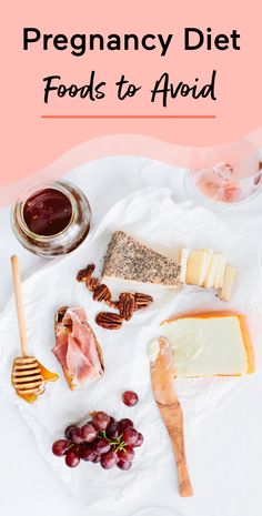 a white plate topped with cheese, meats and nuts next to a jar of jelly