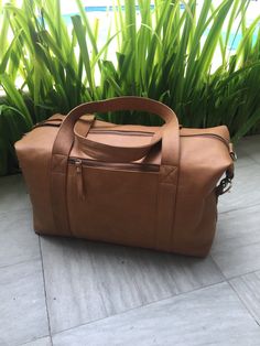 The Maxton Leather Weekender. Adjustable shoulder strap, two fixed handles, external front zip pocket, internal two open pockets and one internal zip pocket. Perfect for the weekend away.  Measurements are within most airlines cabin restrictions. Big Travel Bag, Hand Luggage Bag, Leather Overnight Bag, Leather Holdall, Overnight Travel Bag, Leather Duffel Bag, Leather Weekender Bag, Leather Weekender, Leather Duffel