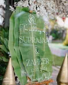 a sign that is on top of a wooden chair in front of some flowers and trees