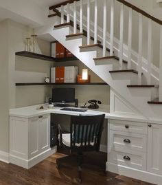 a home office under the stairs with desk and chair