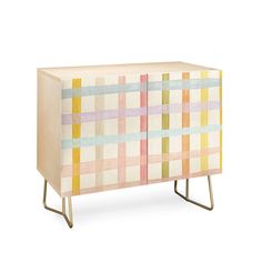 the sideboard is painted in pastel colors and has metal legs that match with the furniture