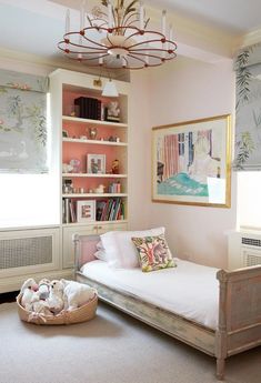 a bedroom with pink walls and white furniture