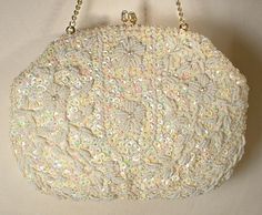 I am SO happy to be offering this beyond beautiful vintage collectible high-end designer "Richere" Art Deco hand beaded warm ivory pearl and sequins and white bead gold flapper purse  perfect for the Bride. I can't tell you how much I adore the design of this purse!  This bag is in near PRISTINE vintage condition. If you've ever seen one of these Richere purses in person you know that photos are not doing it justice or capturing the attention to detail adequately.  It is completely covered with closely hand sewn ivory sequins and white seed beads in a gorgeous floral and fine pattern.  The centers of the flowers are adorned with simulated ivory pearls for even more interest.  The beadwork is done over ivory statiny fabric and the design is the same front and back. The purse closes with a r Vintage White Party Bags, White Vintage Party Bag, Vintage White Clutch Evening Bag, Vintage White Embellished Evening Bag, Vintage Evening Bag With Handwork For Formal Occasions, Vintage Handwork Evening Bag For Wedding, Embellished Cream Evening Bag For Wedding, White Evening Bag With Handwork For Wedding, Vintage Wedding Evening Bag With Handwork