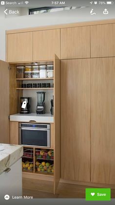 a kitchen with wooden cabinets and white counter tops is shown on the appliance screen