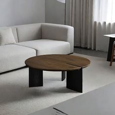 a living room with a white couch and wooden coffee table