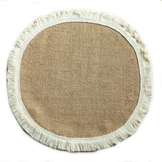 a round rug with fringes on the top and bottom in beige, against a white background