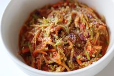 a white bowl filled with shredded vegetables on top of a table