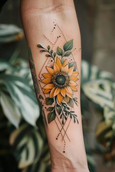 a sunflower tattoo on the left arm and foot, with green leaves around it