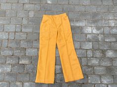 "Vintage 70s Soviet women wool pants, unused yellow orange colour winter pants. 2 pockets front side. Closes with zipper and hook. Size - no size tag, custom made. ♥ Measurements (lying flat) - WAIST 35CM ♥ Total length- 101 cm (39.76) ♥ Waist - 35cm (13.77) ♥ Hips - 49cm (19.29\") ♥ Inseam - 75cm (29.52) ♥ Rise - 27cm (10.62\") WAIST 38.5CM ♥ Total length- 99cm (38.97\") ♥ Waist - 38,5cm (15.15\") ♥ Hips - 54cm (21.25\") ♥ Inseam - 76cm (29.92) ♥ Rise - 26cm (10.23\") ♥ Materials - wool ♥ It is Pants Custom, 70s Women, Wool Mittens, Jaune Orange, Orange Colour, Winter Pants, Vintage Soviet, Wool Pants, Estonia