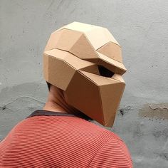 a man wearing a cardboard mask on top of his head