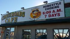 the front of a fast food restaurant with large signs on it's side window