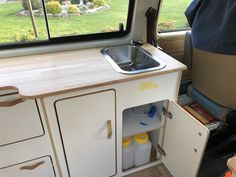 the kitchen sink is built into the side of an rv's storage compartment,