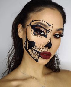 a woman with makeup painted to look like a skeleton face paint on her face and lips