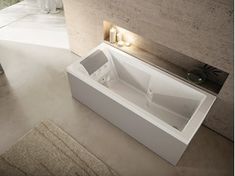 a white bath tub sitting on top of a bathroom floor