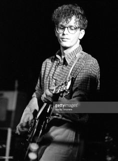 black and white photograph of a man playing an electric guitar