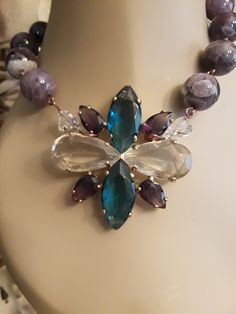 "What a beautiful piece of jewelry. This is a gorgeous round 18mm amethyst stone necklace with vintage glass stone drop has blue clear and purple stones in a unique design on gold toned metal. It's a very classy piece. The necklace is 17\" in length. The drop is 3\" h X 2.5\" w. This center piece is vintage and is in good shape, no flaws outside of natural aging. What a beautiful vintage necklace to add to your collection or give as a gift! Also, comes in nice packaging! If you would like more p Elegant Amethyst Necklace With Large Stone, Multicolor Amethyst Necklaces With Gemstone Accents, Amethyst Stone Necklace, Elegant Purple Multi-stone Necklaces, Multicolor Amethyst Multi-stone Necklace, Luxury Amethyst Multi-stone Necklace, Creative Necklace, Native American Necklace, Black Onyx Necklace