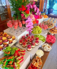 an assortment of desserts and pastries on display at a wedding or bridal party