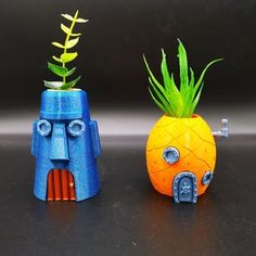 two plastic pineapples with plants growing out of them