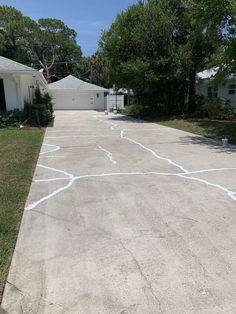 an empty basketball court in front of a house