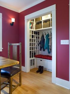 a dining room table and bench in front of an open closet