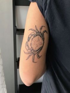 a man with a crab tattoo on his arm