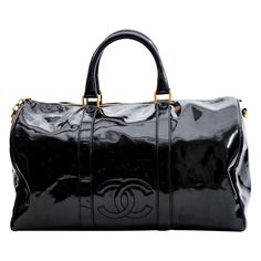 A classic Bowler bag made in the bold and statement black patent leather, this Chanel bag is everything that is highly functional and also extremely stylish. With a gold-tone top zipper closure and a classic bowler shape, this bag provides ample storage space for all your belongings. Featuring dual rolled top handles, a detachable shoulder trap, a gold CC charm, an embellished CC logo on the front, top zip closure and black woven fabric interior lining. Chanel bags with the code 4xxxxxx are manu Classic Black Bags With Glossy Finish, Classic Black Bag With Glossy Finish, Designer Black Bags With Glossy Finish, Luxury Black Patent Leather Bag, Black Glossy Business Bag, Chic Black Patent Leather Bag, Chic Black Bag With Glossy Finish, Classic Patent Leather Bag With Glossy Finish, Classic Glossy Travel Bag