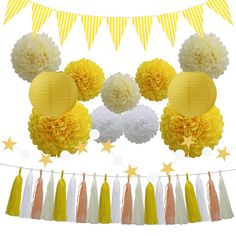 a yellow and white party decoration with tissue pom poms