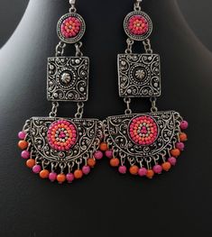 Gather compliments wearing this hand crafted pink, blue or multicolor beaded India chandbali earrings and necklace in oxidized blackened silver, so as to create the patina of a vintage tribal piece. The blackening makes all the fine details stand out dramatically! 5 strand chain drapes effortlessly and dramatically from the bottom of the necklace. Adjustable length using sliding bead on black cotton cord, for a comfortable fit, drop from 9 1/2 in to 18 in. Earrings measure 3 2/2 x 1 3/4 in. on f Silver Chandelier Earrings With Dangling Beads For Festivals, Fusion Style Chandelier Earrings With Dangling Beads, Multicolor Chandbali Danglers For Festival, Bohemian Dangle Chandbalis For Festive Occasions, Bohemian Metal Chandbalis For Party, Fusion Style Chandelier Earrings For Festivals, Festive Handmade Metal Chandelier Earrings, Handmade Metal Chandbali Earrings, Handmade Metal Chandbalis With Dangle