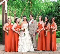 a bride and groom with their bridal party in front of an outdoor gazebo