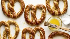 pretzels and a paintbrush on a white surface next to some other pretzels