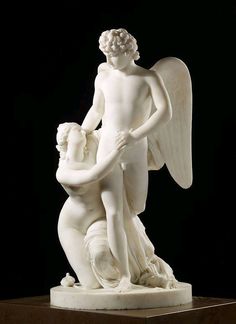 a white statue with an angel holding a child on it's back, in front of a black background