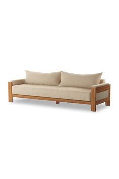 a wooden couch with two pillows on it's back and the seat upholstered