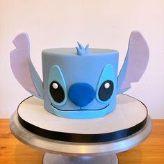 a blue hat with ears and eyes on top of a table