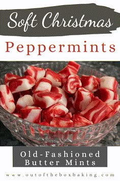 a glass bowl filled with red and white peppermints on top of a table