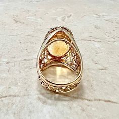 A spectacular vintage 14 karat yellow gold cocktail ring set with a large oval citrine weighing approximately 20 carats. The gem measures 20.20 x 13.83 mm. Citrine is the birthstone for November. This ring is a size 7.75 US / P 1/2 UK. It weighs 11.77 grams. W: 15.80 mm. Band width: from 7 mm to 22 mm at widest. Birthstone: November. Condition: Very Good. - 14 day return policy, no questions asked. - Free insured shipping in the US. - International shipping available. > This ring can’t be resize Yellow Gold Cocktail Ring, Gold Cocktail Ring, Gold Cocktail, Citrine Ring, Cocktail Ring, Cocktail Rings, Ring Set, Citrine, Ring Sets