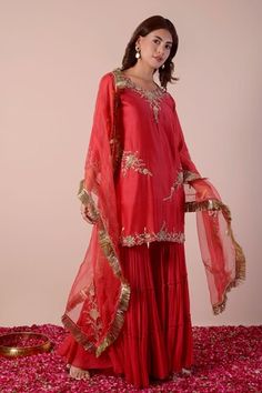 Apple red kurta with sequin, bead, cutdana embroidery in floral placement pattern. Paired with tiered gharara and dupatta. - Aza Fashions Festive Red Sharara With Dori Work, Red Palazzo Set For Celebration On Eid, Red Sharara With Gota Work For Celebration, Red Sharara With Dori Work For Celebration, Red Chanderi Sharara For Celebration, Red Sharara For Eid Celebration, Red Unstitched Sharara For Transitional Season, Red Sharara For Celebration With Traditional Drape, Celebration Red Sharara With Cutdana