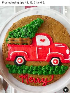 a red truck with a christmas tree on it is sitting in front of a white plate